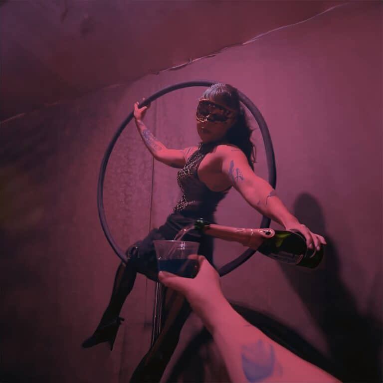 Energetic performer in a hoop at Velvet Edge Entertainment event, celebrating luxury nightlife and entertainment.
