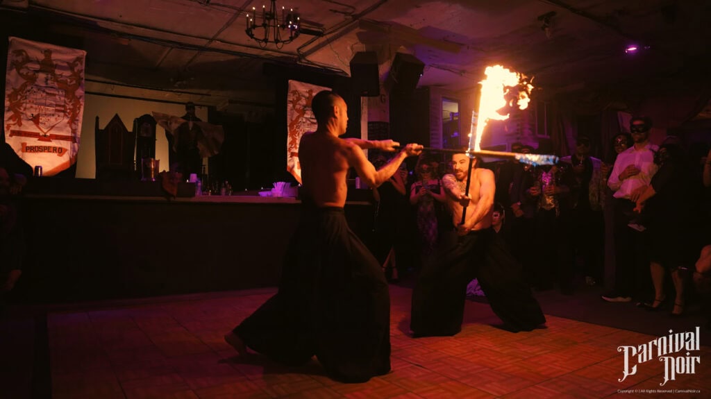 Vivid fire performance show at Velvet Edge Entertainment with fire performers and audience in a nightclub setting.